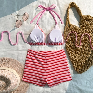 Detailed flat lay of striped bikini set with white inner chest pads and high waist shorts