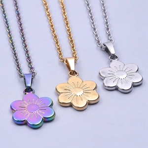 Three minimalist five-petal flower pendants in rainbow, gold and silver finishes