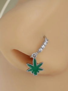 Macro view of silver nose ring with white zircons and green leaf oil drip pendant