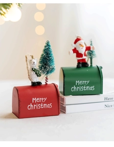 Close-up of festive red and green metal mailboxes with Santa and polar bear figurines