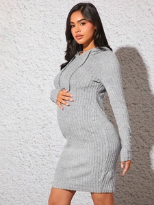 Close-up of maternity dress side drawstring detail on gray knitted long sleeve fabric