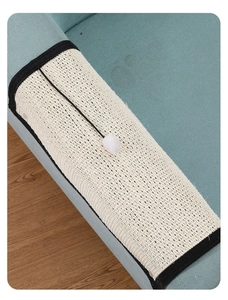 Detail of durable sisal scratching mat for sofa protection with a plush ball toy attached
