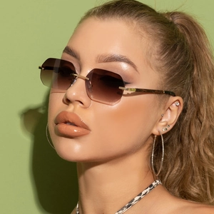 Detail of rimless gradient sunglasses with wood grain temples on a female model