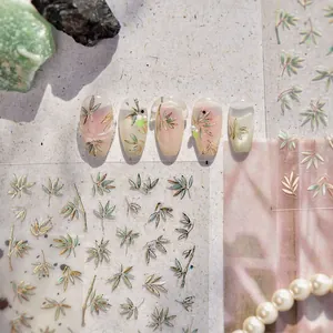 Golden bamboo leaf nail art stickers featuring Chinese style green and gold leaf patterns