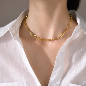 Close-up of golden square pendant necklace on model showing delicate chain details