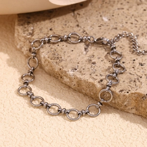 Close-up of 14K gold plated stainless steel anklet on a natural stone background