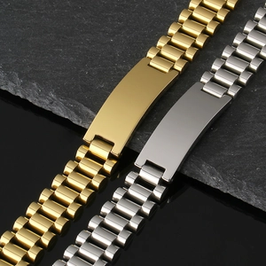 Detail of gold and silver stainless steel watch link bracelets with engravable blank plates