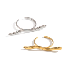 Minimalist geometric wave open rings in gold and silver finish on a clean white background
