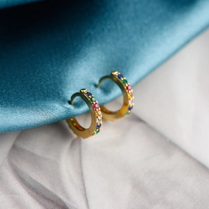 Macro shot of 925 sterling silver hoop earrings with vibrant colorful cubic zirconia gems