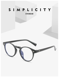 Detail view of round black eyeglass frames showing anti-blue light lenses and retro hinge