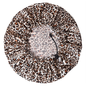 Detail of leopard print shower cap showing adjustable drawstring and PEVA lining