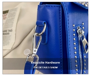 Detail of bright blue litchi grain bag with silver metal hooks and punk style rivets