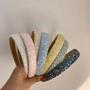 Group of colorful wide headbands with shiny glitter finish in pastel tones