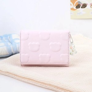 Detailed view of pink PU leather wallet with embossed bear pattern and acrylic charm