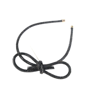 Sparkling black rhinestone bow headband with elegant gold-tipped ends for hair styling