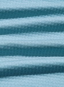 Macro shot of blue gradient knitted fabric with detailed horizontal striped texture
