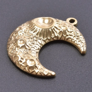 Detailed view of golden moon pendant with realistic lunar surface crater texture