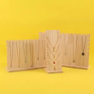 Solid wood necklace display stands with natural grain and slots on bright yellow backdrop