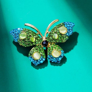 Elegant butterfly brooch with green-blue gradient rhinestones and cat-eye stones