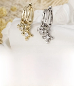 Macro detail of copper cross earrings with inlaid cubic zirconia and sizing specs
