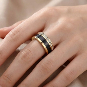 Close-up of rose gold titanium steel ring with black glitter and clear zircons on hand