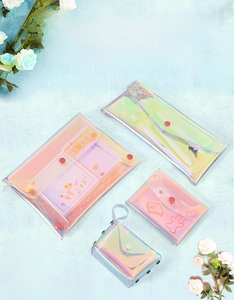 Macro detail of laser PVC glitter coin purses with cute prints and metal button snaps
