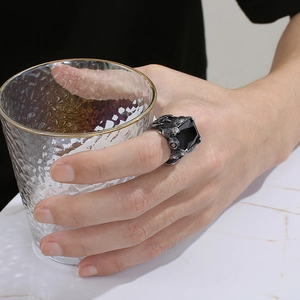 Vintage gothic men's stainless steel ring featuring a large black stone on model's hand