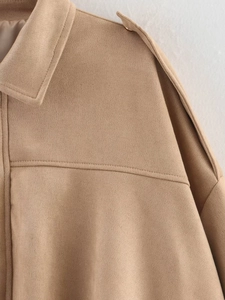 Detailed close-up of khaki suede bomber jacket collar with premium shoulder epaulettes