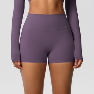 Detail of high-waisted purple yoga shorts and crop top set in breathable elastic fabric