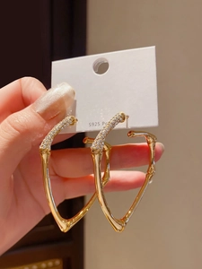 Detailed shot of S925 silver needle bamboo heart earrings with inlaid crystals