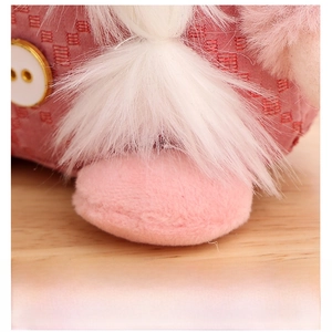 Close-up of pink sequined gnome plush with soft faux fur and detailed fabric texture