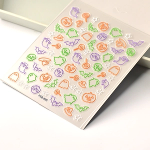 Detail of 5D embossed Halloween nail stickers featuring ghost, pumpkin, and bat designs
