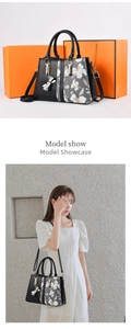 Fashionable black tote bag for women with floral print side detail and bow charm