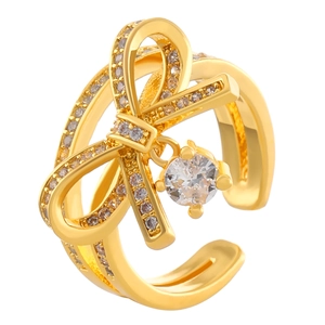 Golden bow ring with crystals and round pendant in a minimalist open design