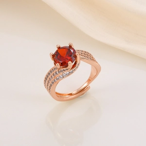 Detailed shot of a rose gold ring with a 3-carat red gemstone and white zircon stones