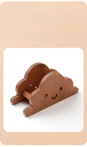 Cloud-shaped wooden trivet showing natural wood grain and laser-cut smiley face detail
