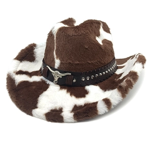 Detail of plush cow print western hat with silver bull head ornament and metal studs