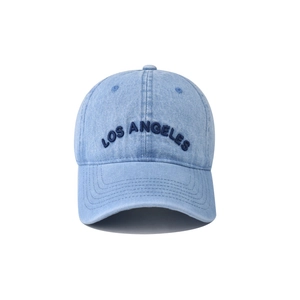 Detailed close-up of blue washed denim texture and Los Angeles embroidery on baseball cap