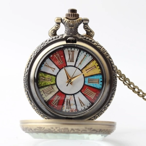 Detailed macro view of vintage bronze pocket watch with colorful Roman numeral dial and chain