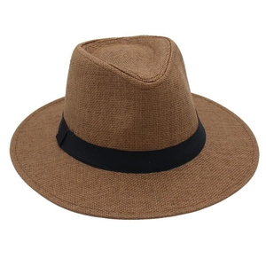 Detail of classic brown straw fedora with fine weaving and black ribbon band