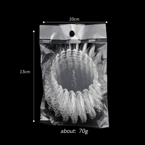 Detail of 20-color oval nail display tips in clear plastic stacked inside OPP packaging