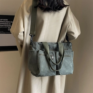 Large military green corduroy shoulder bag for women featuring multiple front pockets