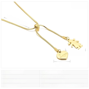 Detail of gold snake chain necklace featuring a Love heart and girl charms