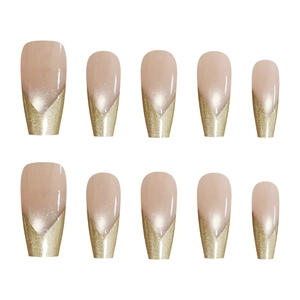 Golden V-tip French style press-on nails in nude base and mid-length coffin shape