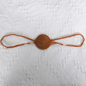 Close-up of handmade crochet nose accessory in brown yarn for funny Halloween props