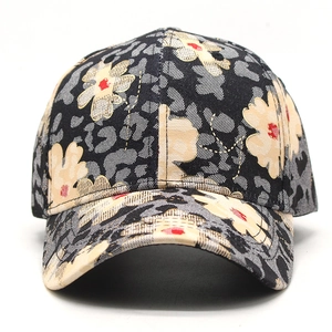 Close-up of baseball cap featuring floral prints and leopard patterns on thick canvas fabric