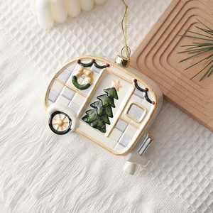 Vintage camper Christmas ornament in cream with gold trim and festive wreath details