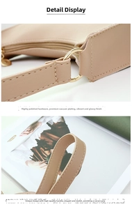 Detail of high-polish light gold round hardware and stitching on beige leather handbag
