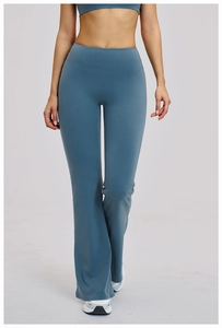 Detailed close-up of high-waisted flared yoga pants in dusty blue with side split hem