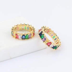 Detail of bohemian rainbow zircon rings with colorful baguette stones on gold metal